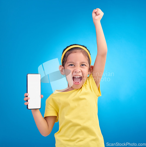 Image of Phone, winner and child with mockup screen on blue background for social media, website and mobile app. Advertising, brand space and girl happy, excited and celebration for success, goals and winning