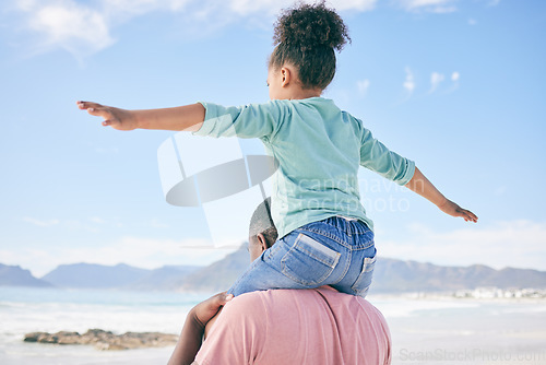 Image of Beach, black man with child on shoulders in nature on playful family holiday in Australia with freedom and energy. Travel, happy father and girl playing, flying and bonding together on fun vacation