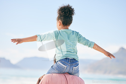 Image of Beach, black man with child on shoulders from back on playful family holiday in Australia with freedom and fun. Travel, fun and happy father and girl playing, flying and bonding together on vacation.