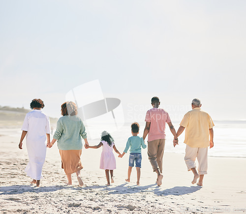 Image of Family at beach, holding hands and generations outdoor, people walk on sand with grandparents, parents and kids. Together, support and trust, travel to Bali with love, care and bond with back view