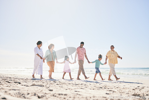 Image of Happy family walking on beach holding hands with children for love, bonding and quality time together. Relax, smile and kids with mom, dad and grandparents on holiday, summer vacation and weekend