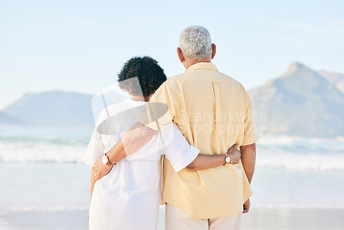 Image of Senior couple at beach, hug and travel, retirement and love outdoor, vacation with ocean view and relax in nature. Peace, zen and tropical island, man and woman watching sea waves, back and wellness