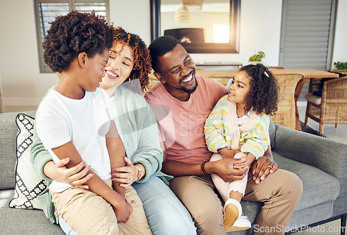 Image of Happy family, embrace and laugh on a sofa, cheerful and smile while bonding and relax in their home. Laughing, children and parents on couch together, hug and loving in a living room on weekend