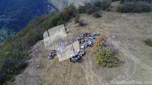 Image of Aerial drone view of ATV quads on a dirt trail in forests. Off-road group team club enthusiasts having fun while driving countryside roads.