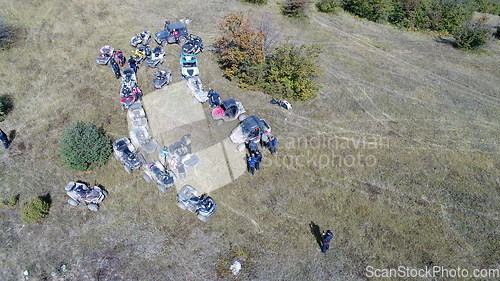 Image of Aerial drone view of ATV quads on a dirt trail in forests. Off-road group team club enthusiasts having fun while driving countryside roads.