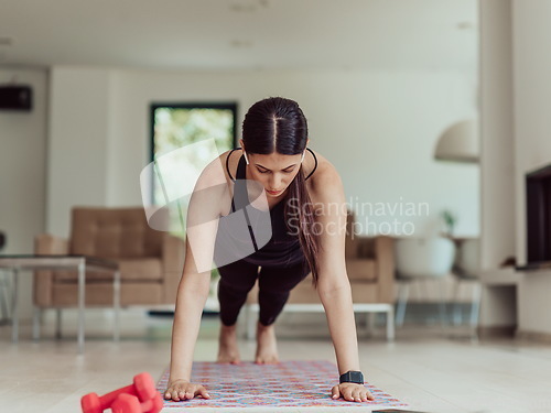 Image of Young Beautiful Female Exercising, Stretching and Practising Yoga with Trainer via Video Call Conference in Bright Sunny House. Healthy Lifestyle, Wellbeing and Mindfulness Concept.