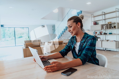 Image of Woman sitting in living room using laptop look at cam talk by video call with business friend relatives, head shot. Job interview answering questions.