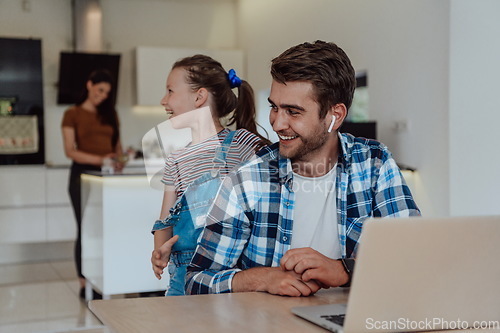 Image of Father and daughter in modern house talking together on laptop with their family during holidays. The life of a modern family