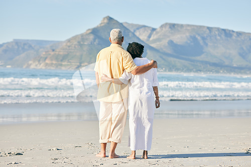 Image of Old couple at beach, hug and travel with retirement and love outdoor, vacation with ocean view and relax in nature. Peace, zen and tropical island, man and woman watching sea waves, back and wellness