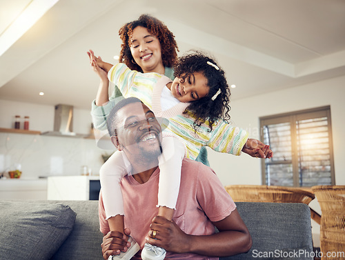 Image of Black family, father and daughter playing with mother on living room sofa together for fun bonding at home. Happy dad carrying child for piggyback ride with mom on lounge couch enjoying holiday break