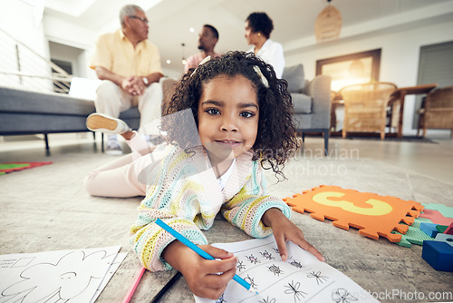 Image of Child portrait, coloring homework and pencil art of a girl lying on a living room carpet with family at home. House, color drawing learning and creative development of young kid with a school book