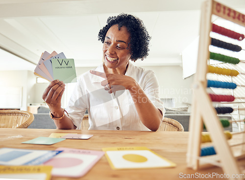 Image of Woman, smile and alphabet for learning letters, words or education with abacus and shapes on table at home. Happy female teacher, tutor or educator smiling holding and pointing at letter cards