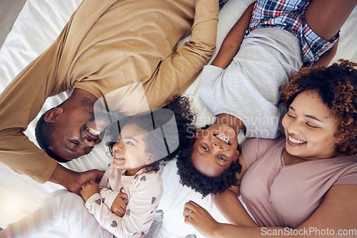 Image of Above, happy and black family laughing in bed, smile and bonding while resting in a home with care. Top view, relax and children waking up with mother and father in a bedroom, playful and having fun