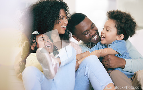 Image of Happy family, laugh and relax on a sofa, bonding and playing in their home together. Laughter, smile and children with parents on a couch, cheerful and enjoy game, moment and weekend in a living room