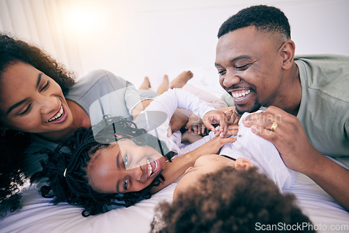 Image of Laugh, tickle and morning with black family in bedroom for wake up, bonding and affectionate. Weekend, smile and care with parents and children at home for playful, funny and free time together