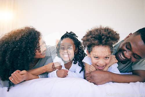 Image of Happy, laugh and morning with black family in bedroom for wake up, bonding and affectionate. Weekend, smile and care with parents and children at home for playful, funny and free time together