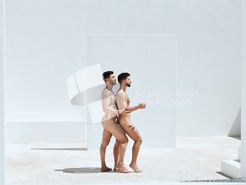 Image of Art, creativity and naked men together in pose, embrace and sun in Greek architecture, photography and lgbt love. Creative pride aesthetic, artistic passion and nude gay couple with athletic body.