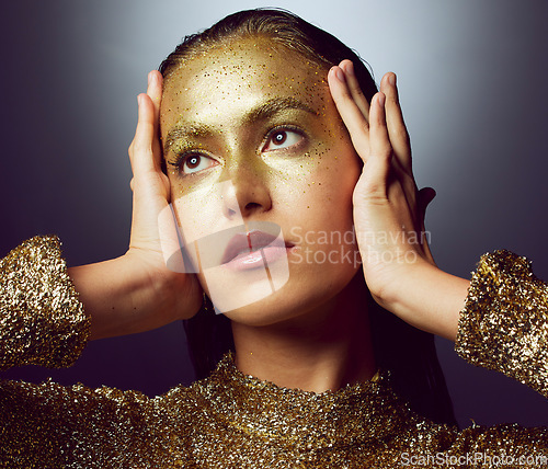 Image of Glitter, gold and makeup with woman in studio for fashion, beauty and creative art. Glamour, trendy and cosmetics with female isolated on black background for luxury, elegance and shimmer sparkles