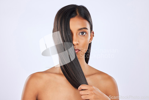 Image of Woman, hair and beauty and haircare with cosmetics, keratin treatment and portrait on studio background. Serious, Indian female with straight hairstyle and skin glow, Brazilian and cosmetic care