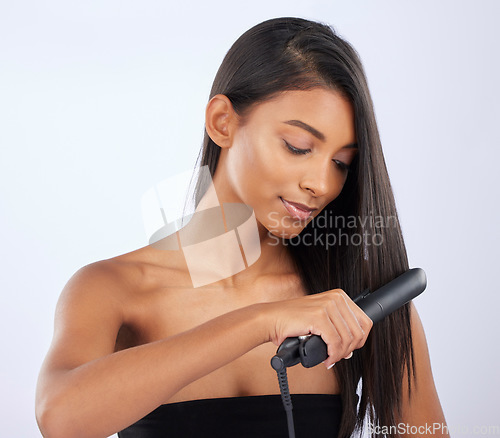 Image of Natural, woman or hair straightener in studio for beauty self care or style treatment on white background. Face, Indian girl model or salon spa equipment for ironing in grooming routine for styling