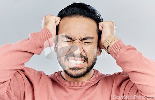Image of Man, face and frustrated with stress headache, anxiety and mental health isolated on studio background. Male with eyes closed, depression and distress, person in pain with migraine and burnout