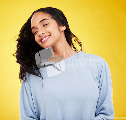 Image of Young woman, hair and beauty, happy and satisfaction with gen z, fashion on yellow studio background. Happiness, youth and Indian female with smile, haircare and cosmetics with growth and shine