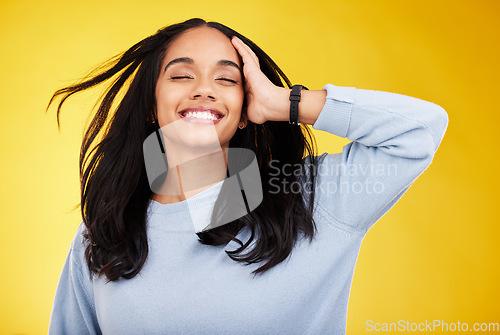 Image of Happy, freedom and relief with a woman on a yellow background in studio feeling carefree or cheerful. Smile, relax and calm with an attractive young female posing eyes closed in a peaceful mood