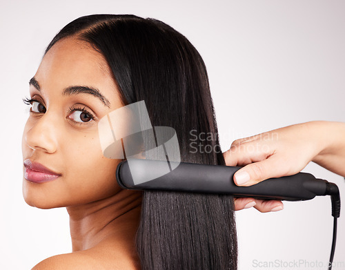 Image of Woman flat iron and studio portrait with hair care, wellness and heat treatment by white background. Girl, model and healthy glow at hairdresser with electric tools for cosmetics, change and beauty