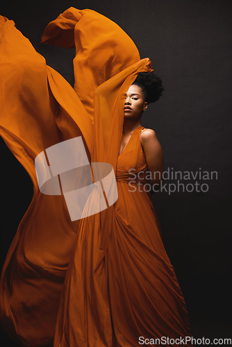 Image of Black woman, wind and art in fashion, fabric on dark background and motion in aesthetic movement. Flowing silk, fantasy and artistic beauty, sensual African model in creative designer dress in studio