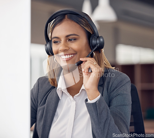 Image of Call center, indian woman and smile at office computer in business, microphone and tech support and happiness. Telemarketing consultant, desktop pc and female crm with communication for customer care