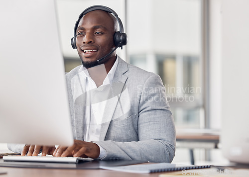 Image of Call center, man and computer for typing with smile, reading and tech support with happiness at job. African telemarketing consultant, desktop pc and writing email for communication in customer care
