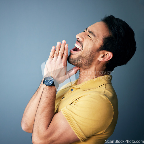 Image of Praying, shouting and begging with a man in studio on a gray background desperate for help or assistance. Mental health, screaming and asking with an angry male suffering from grief, pain or loss