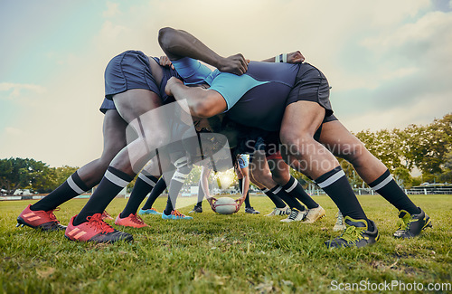 Image of Rugby fitness, scrum or men training in stadium on grass field in match, practice or sports game. Teamwork, ball or strong athletes in tackle exercise, performance or workout in group competition