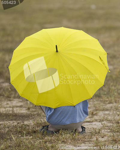 Image of Man with yellow umbrella