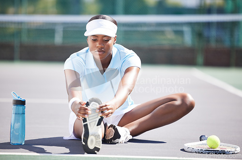 Image of Warm up, tennis and leg stretching by black woman at court for sports, fitness and training on blurred background. Exercise, preparation and foot stretch by athletic girl player on floor before match