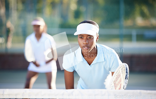 Image of Tennis, sport and serious black woman on outdoor court, train and fitness, collaboration and ready for game. Exercise, workout and female wait for serve, determined athlete and workout with racket