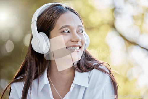 Image of Headphones, music and woman in nature streaming podcast or radio. Thinking, smile or happy young female with idea, listening or enjoying audio album, song or sound track outdoors in park with headset