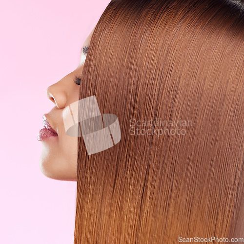 Image of Beauty, hair and profile of black woman isolated in studio with pink background for salon advertising. Haircare, straightener and Brazilian hairstyle on model for luxury growth product promotion.