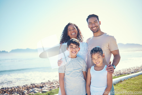 Image of Happy, smile and portrait of family at beach for vacation, bonding and summer break. Holiday trip, travel and care with parents and children on field by sea for positive, affectionate or quality time