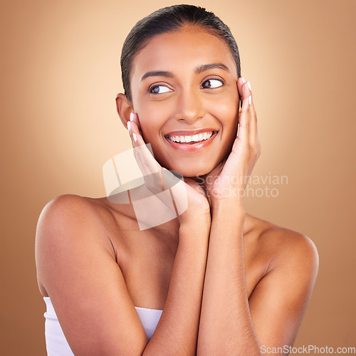 Image of Beauty, skincare and touch with indian woman in studio for happy, spa treatment and facial. Cosmetics, self care and glow with model on brown background for satisfaction, empowerment and confidence