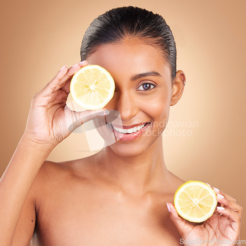 Image of Skincare, woman portrait and lemon for health, wellness and beauty of a young model with happiness. Studio, smile and healthy fruit with vitamin c and fruits nutrition for facial and dermatology