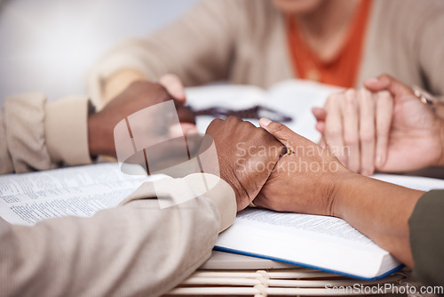 Image of Praying, holding hands and religious people worship God as the Christian faith using the bible and being spiritual. Support, gratitude and closeup of thankful group pray together for religion