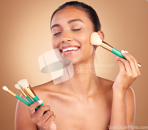 Image of Makeup brushes, smile and woman with natural beauty, wellness and happiness from cosmetics. Facial skin glow, happy and cosmetic artist brush of a young female model with self care in a studio