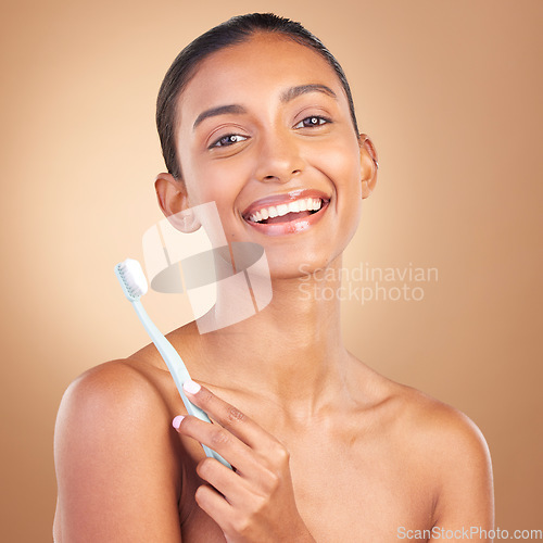 Image of Beauty, smile and toothbrush with portrait of indian woman in studio for brushing teeth, dental and cosmetics. Oral hygiene, clean and self care with model on brown background for routine and health