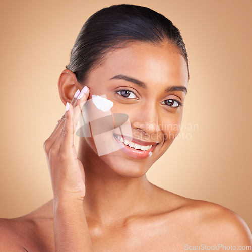 Image of Skincare, sunscreen and portrait of a happy woman with cosmetic and spa cream. Isolated, studio background and young model with a smile from face cleaning, cosmetics and dermatology facial product