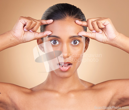 Image of Beauty, surprise portrait and woman forehead wrinkles with a female squeeze face with shock. Isolated, studio background and cosmetic botox change of a model holding clean skin for plastic surgery