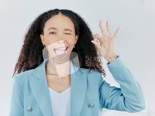 Image of Business woman, okay sign and wink emoji in studio for agreement, support and success. Face portrait of female person with hand gesture for thank you, perfect or approval isolated on white background