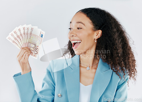 Image of Winner, finance and cash with a business woman in studio on a gray background looking surprised or happy. Economy, wealth and money with a female employee holding euro bills for investment