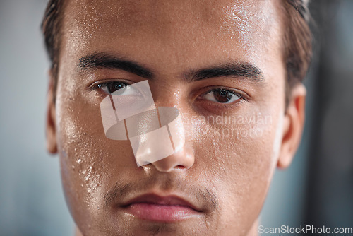 Image of Portrait, sweat and intense with a sports man closeup in the gym for a cardio or endurance workout. Fitness, exercise and focus with a male athlete taking a break after health training for wellness