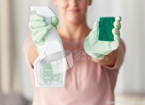 Image of Woman, hands and housekeeping with detergent and sponge for spring cleaning, disinfection or dirt removal at home. Hand of female cleaner holding spray bottle and scrub with rubber gloves for hygiene